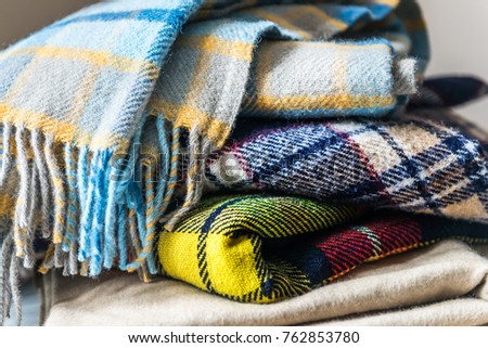 Stack of woolen checked blankets, autumn and winter concept Royalty-Free Stock Photo #762853780