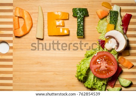 word diet from raw food lies on a board