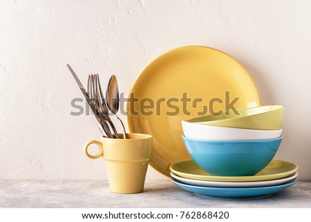 Crockery and cutlery on a light table with copy space. Royalty-Free Stock Photo #762868420