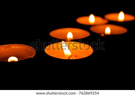 Round candles on a black background