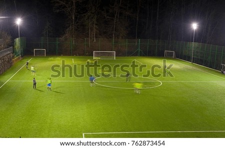 amateur football team training at night