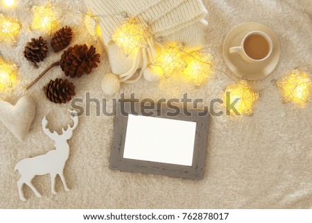 Empty wooden photo frame over cozy and warm fur carpet. For photography montage. Top view