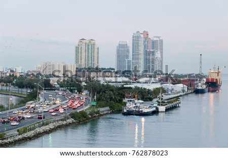 The view at dusk of busy MacArthur Causeway and Miami Beach skyline in a background (Florida).