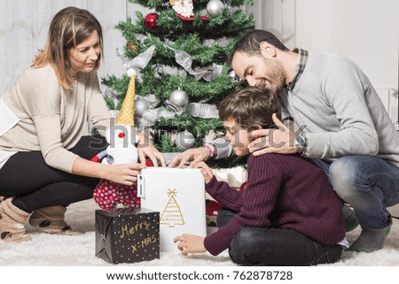 Happy family giving christmas gifts