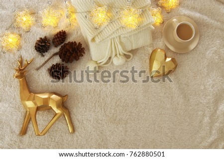 pine cones and cup of cappuccino over cozy and fur carpet. Top view