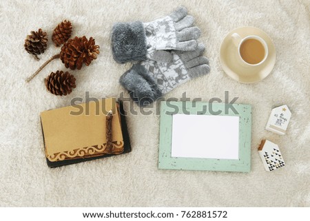 Empty wooden photo frames over cozy and warm fur carpet. Top view. For photography montage