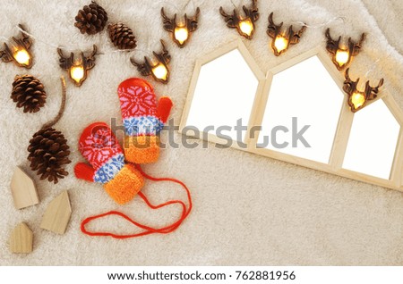 Empty houses shape wooden photo frames over cozy and warm fur carpet. For photography montage. Scandinavian style design. Top view