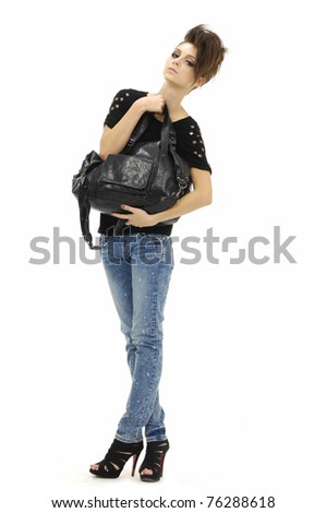 Young stylish slim in jeans holding bag