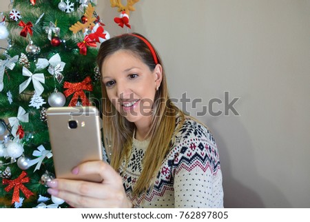 Beautiful pregnant woman is taking a selfie picture, close up