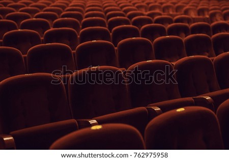 Red armchairs of old theater as conceptual background.