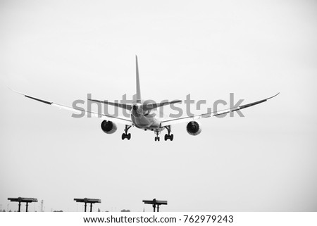 Black and White picture of Aeroplane landing on a runway 
