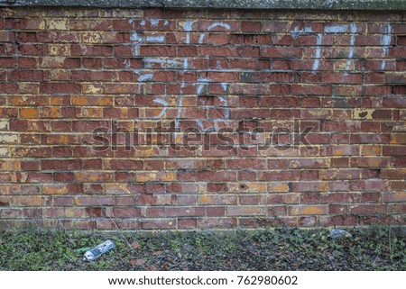Old spray can against graffiti brick wall