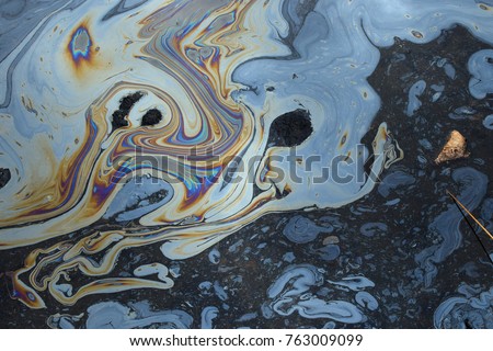 Iridescent colors abstract shapes on tar water surface of natural asphalt pit. Royalty-Free Stock Photo #763009099