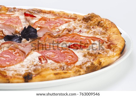 Tasty pizza with ham and tomato on light background