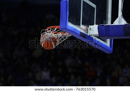 Basketball ball, board and net on black background sports hall