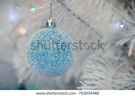 blue balls on a white Christmas tree