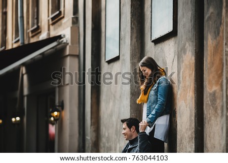 The lovely couple in love standing near building