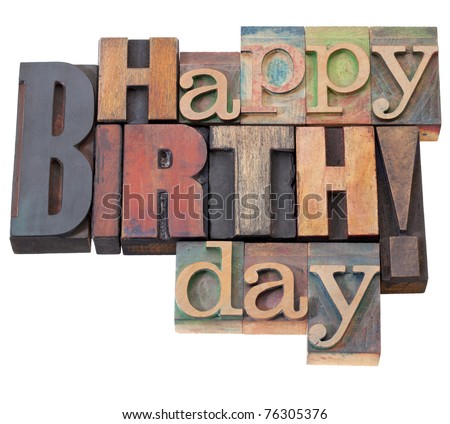 Happy Birthday in antique wood letterpress printing blocks, isolated on white
