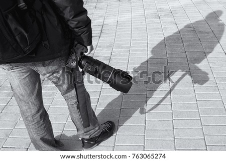 Dark shadows Of Photograph  walking across pavement