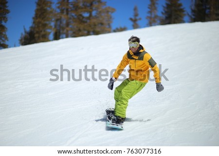 Snowboarder enjoying sunny day in Mammoth, California. Winter sports. Smile and ride, positive sport vocation. Royalty-Free Stock Photo #763077316