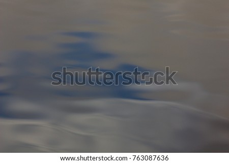 Waves glow on the water surface. 