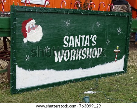 sign with the  saying Santa's workshop and picture of Santa and the north pole