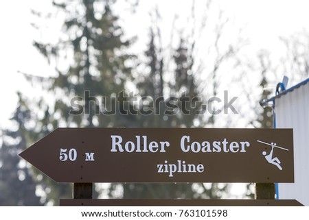 Information sign with words "roller coaster zipline" on it
