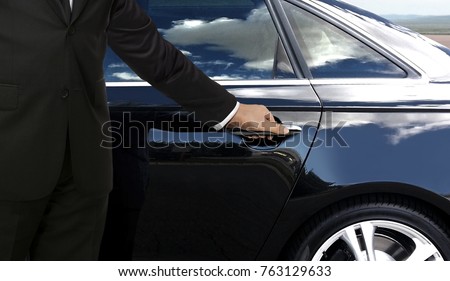 Driver hand opening car door Royalty-Free Stock Photo #763129633
