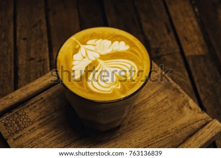 Close up  coffee cup on the wooden board, selective low key tone