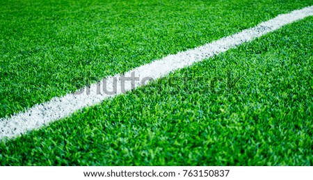 White line on artifact grass sport field for texture background
