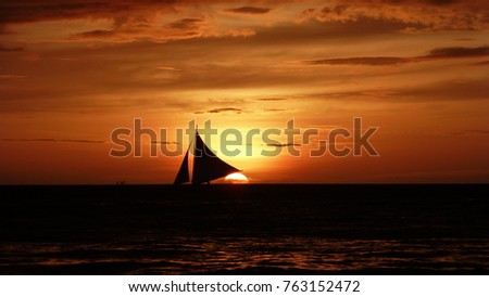 Beautiful picture of a sail boat in the sunset in the tropics of Boracay, Philippines