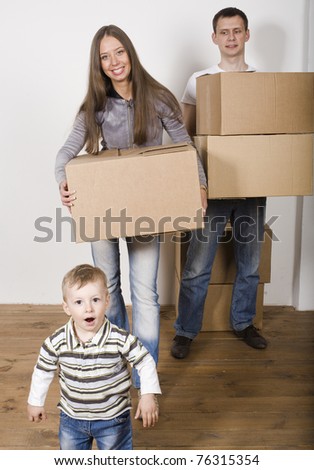 stock-photo-smiling-family-in-new-house-playing-with-boxes