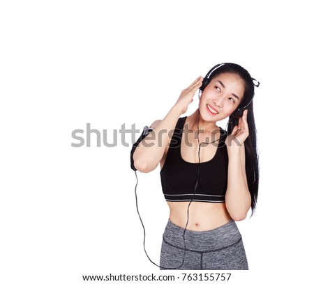 young smiling fitness woman listening to music with earphones isolated on a white background