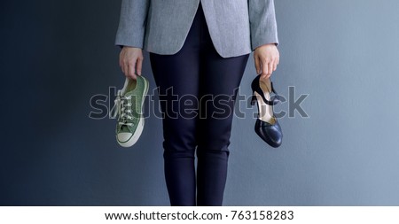 Work Life Balance Concept, present by Business Working Woman holding a High Heal and Sneaker Shoes, Croped image with Copy Space  Royalty-Free Stock Photo #763158283