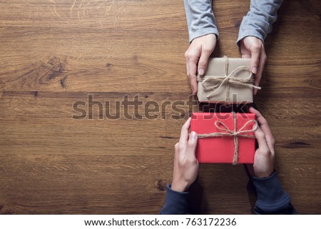 Gives a gift Christmas and new year presents laid on a wooden table background, copy space.