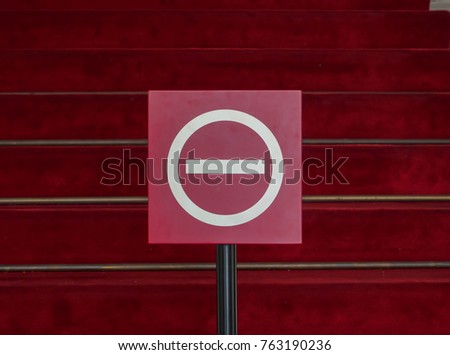 Stop Sign. No entry sign. The background is red carpet.