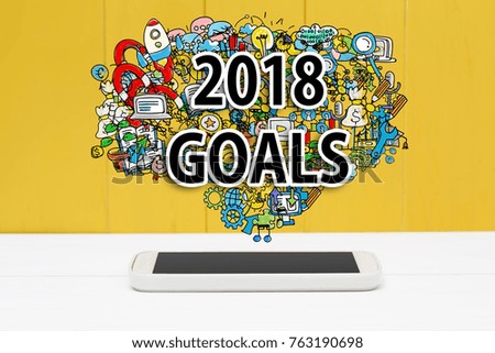 2018 Goals concept with smartphone on yellow wooden background