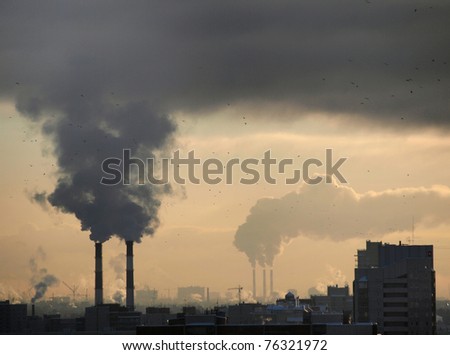 Color photograph of industrial buildings at sunset Royalty-Free Stock Photo #76321972