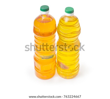 One plastic bottle of the sunflower oil and one bottle of the corn oil on a white background
