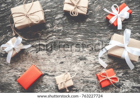 Christmas background, Christmas present brown gift boxes handmade with rope ribbon bow and decorating elements as frame on wooden background. Creative flat lay and top view composition and copy space.