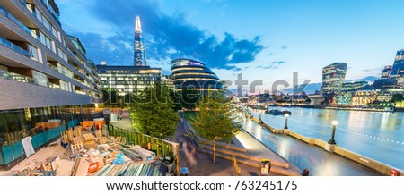 Modern city buildings on the southern riverside at night, London - UK.