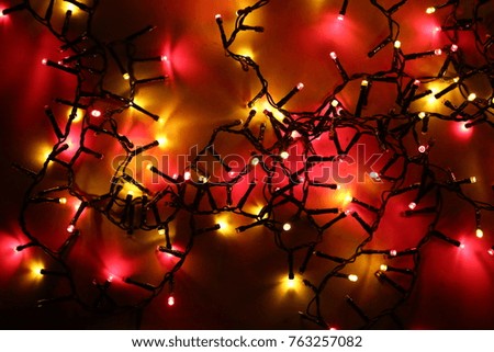 Christmas and New Year background. Color garland in the dark.