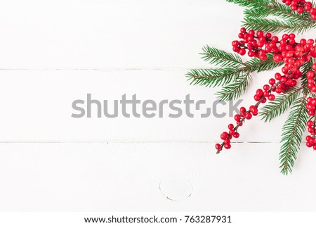 Christmas composition. Fir tree branches and red berries on white background. Christmas, winter, new year concept. Flat lay, top view, copy space