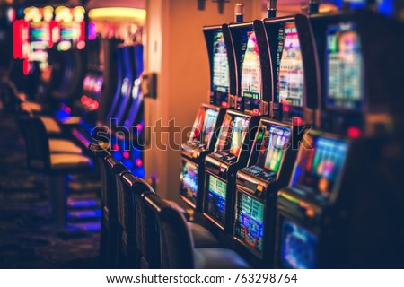 Rows of Casino Slot Machines with Shallow Depth of Field. Las Vegas Gambling Theme. Royalty-Free Stock Photo #763298764