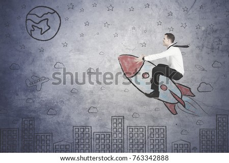 Picture of American businessman looks happy while flying with a rocket above city