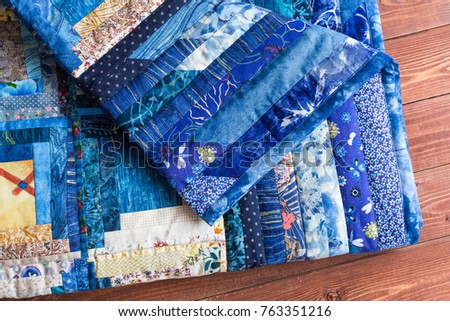 blanket, laziness, relaxation concept - two sides of one handcrafted covering decorated by blue stripes different shades whith pictures of bugs, turtles and clouds