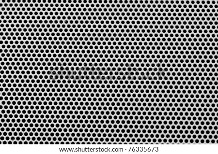 Background sheet of metal covered with lines of circular holes. Royalty-Free Stock Photo #76335673