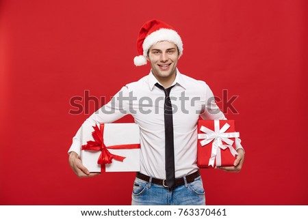 Christmas Concept - portrait happy Santa christmas businessman exciting with his gift over red background.