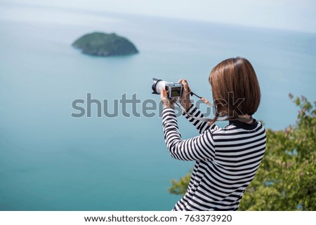 Hipster woman take a photo for travel look view the sea