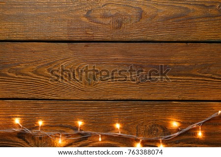 Image on top of wooden surface of burning garland.